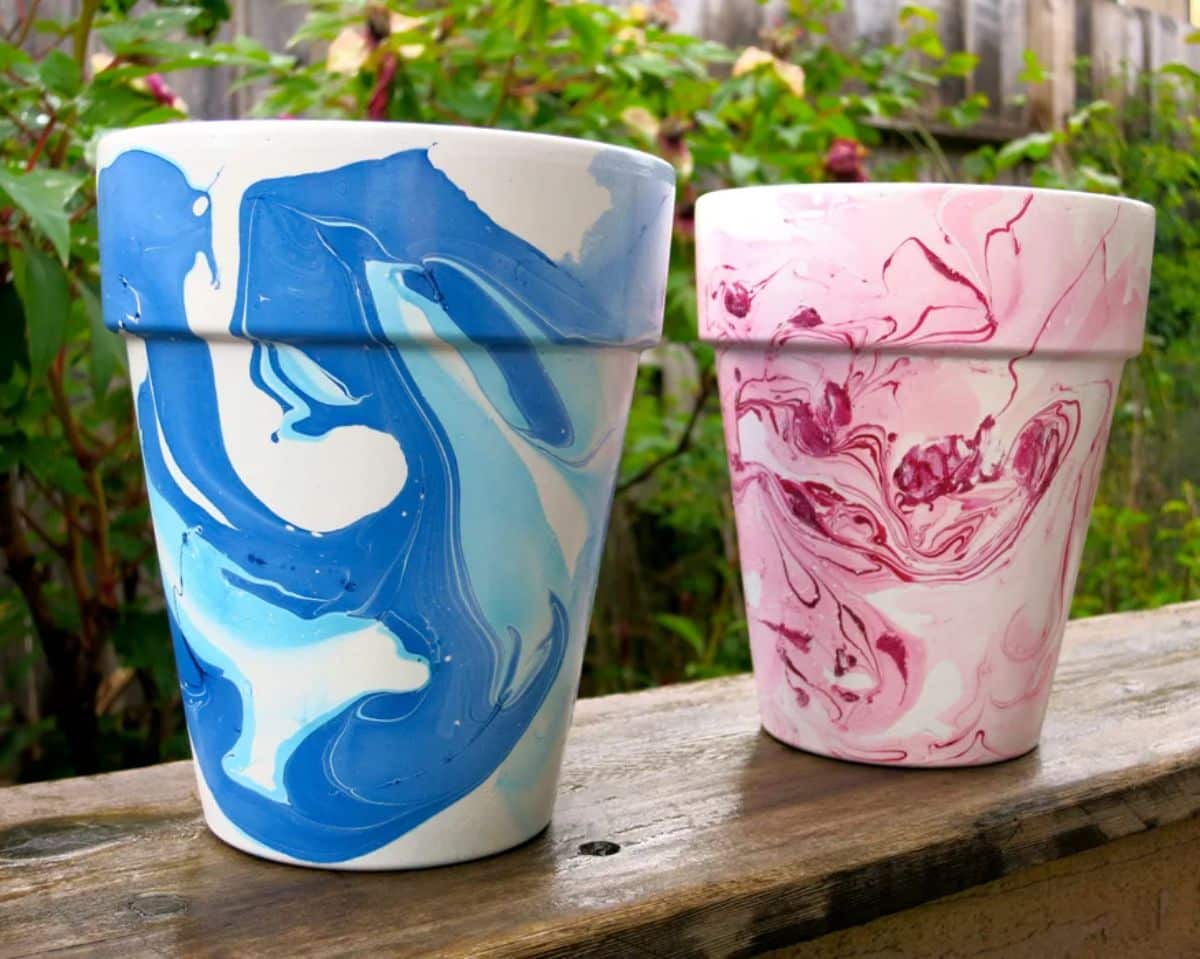 Two nail polish hand-painted flowerpots.