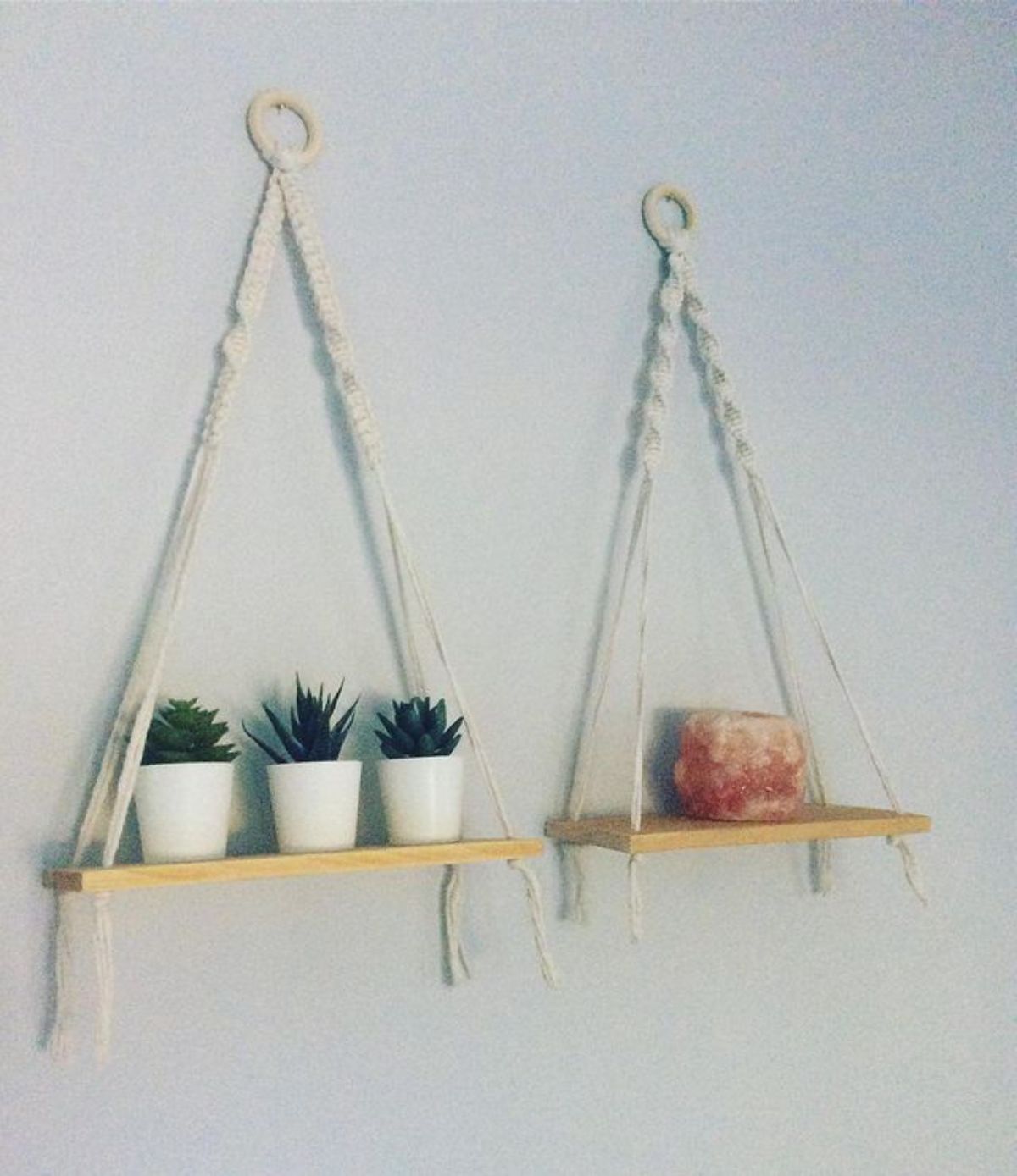 DIY Affordable Macrame Shelves with plants in pots and a fragrance candle.